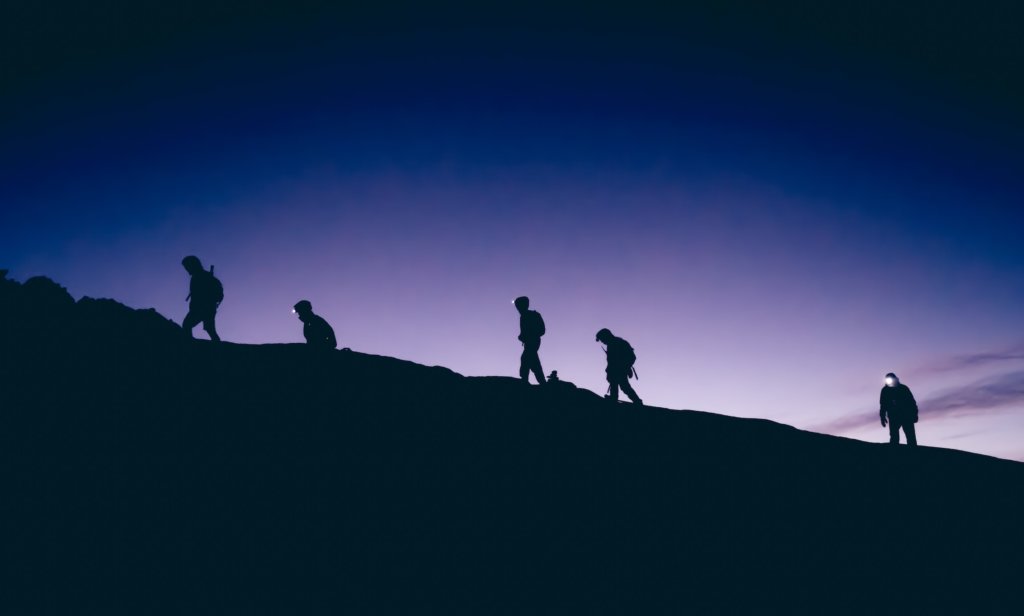 group of people climbing a mountain