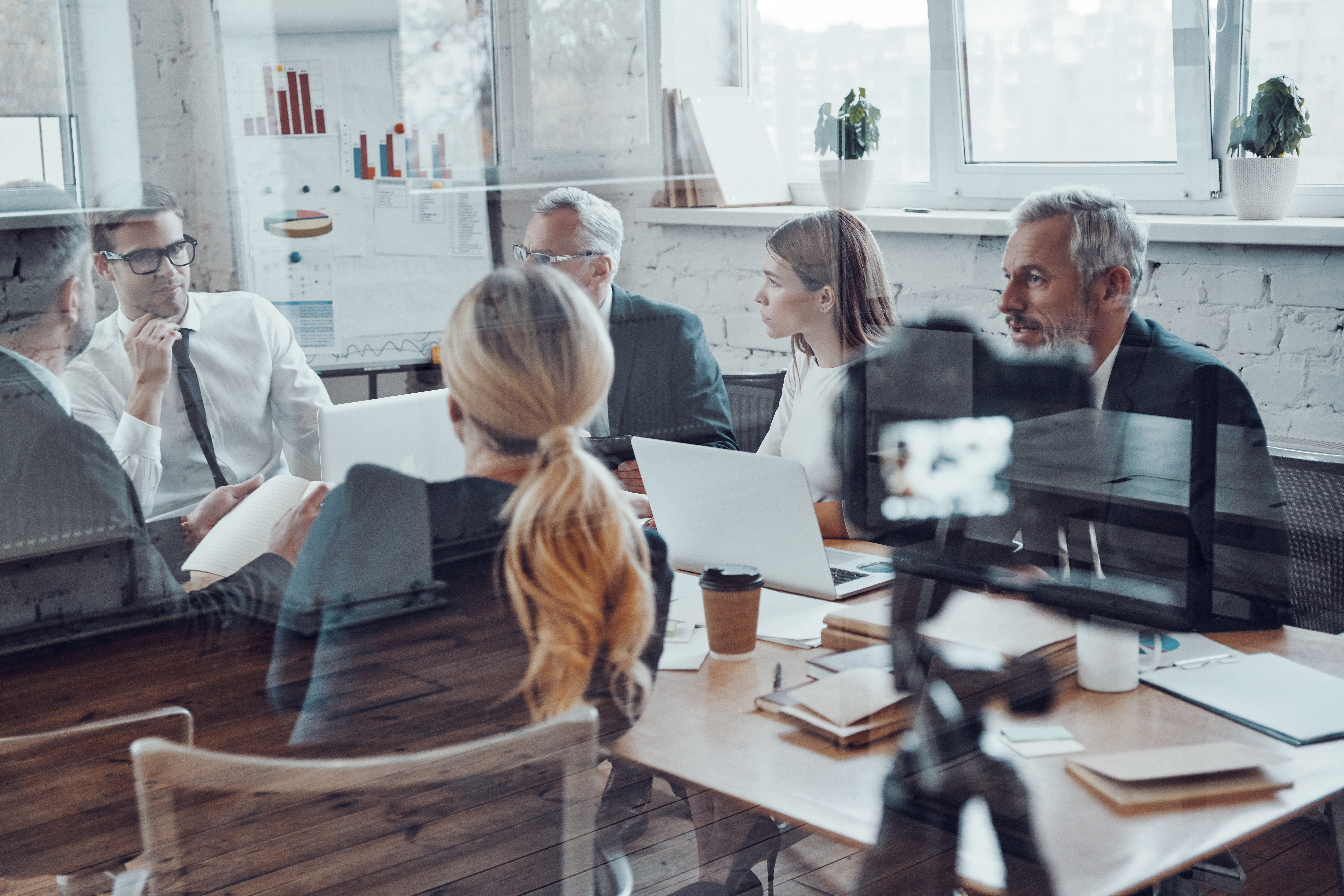 Successful business team discussing strategy while filming staff