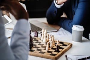 strategic chess game with two players while drinking coffee